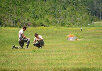 Senior Airman Daniel Johnson, 1st Special Operations Civil Engineer Squadron explosive ordnance disposal journeyman, and Tech. Sgt. Joseph Vollmer, 1st SOCES NCO in-charge of EOD supply, builds a clean-up charge to destroy any remaining explosives during an explosive ordnance demonstration on Hurlburt Field, Fla., Aug. 5, 2015. The EOD Airmen held an explosives demonstration for chaplain candidates to showcase the effects of explosives and strengthen ties between both career fields. (U.S. Air Force photo/ Senior Airman Meagan Schutter)