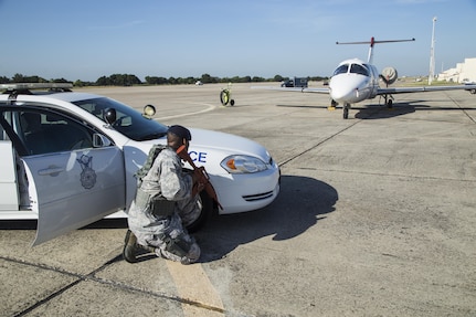 Senior Airman Mercedes Lacy, 902nd Security Forces Squadron patrolman, practices protective postures while guarding a hijacked T-1A Jayhawk during an anti-hijacking exercise Aug. 11 at Joint Base San Antonio-Randolph. Involving key units such as the 902nd Security Forces Squadron, 12th Flying Training Wing and 359th Medical Group, contingency planning exercises are held on a regular basis each year to develop clear pathways of communication in the case of an emergency.