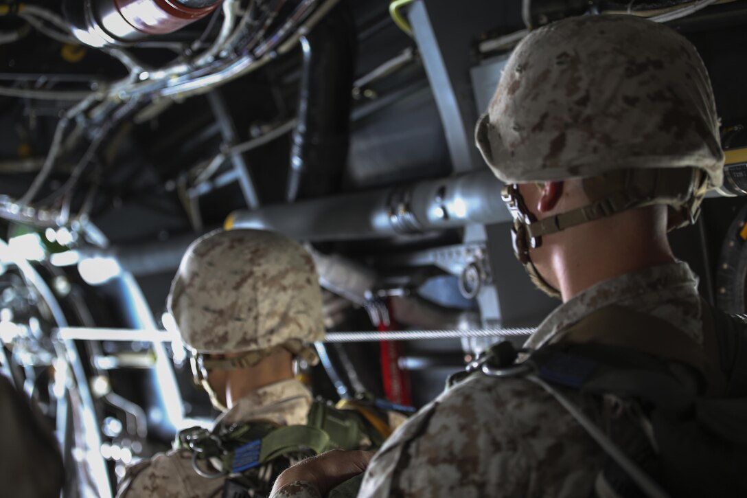 Marine parachute riggers with 2nd Radio Battalion prepare to execute a low level static-line jump from an MV-22 Osprey above Marine Corps Base Camp Lejeune, N.C., Aug. 18, 2015. The Marines jumped form an altitude of 1,250 feet into Landing Zone Canary. (U.S. Marine Corps photo by Cpl. Paul S. Martinez/Released)