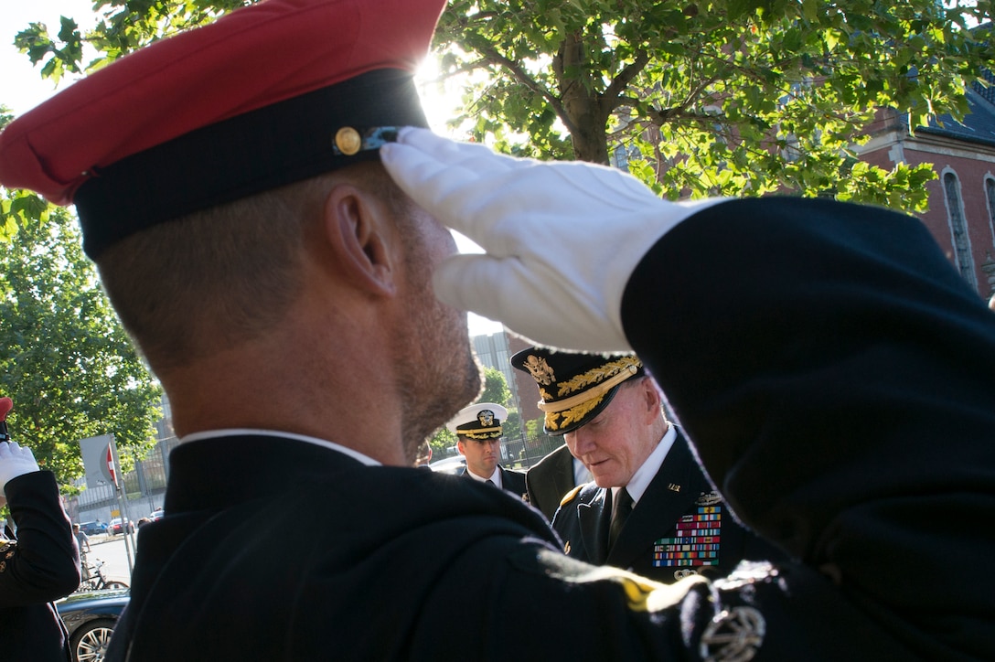 A Danish soldier salutes U.S. Army Gen. Martin E. Dempsey, chairman of the Joint Chiefs of Staff, at the Danish Defense Ministry in Copenhagen, Denmark, Aug. 18, 2015. DoD photo by D. Myles Cullen/