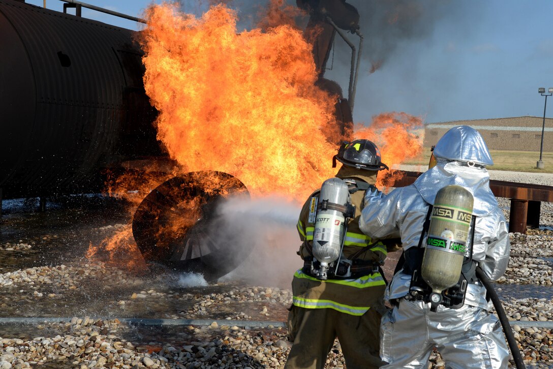 A Del Rio city firefighter, left, attempts to suppress the flames, while a Laughlin firefighter provides assistance during an aircraft live-fire training exercise on Laughlin Air Force Base, Texas, Aug. 19, 2015. The Del Rio Fire Department participates in the “aircraft live-fire” training exercise at least once a year, and the training is designed to familiarize firefighters with the techniques used in an aircraft fire. (U.S. Air Force photo by Airman 1st Class Brandon May)

