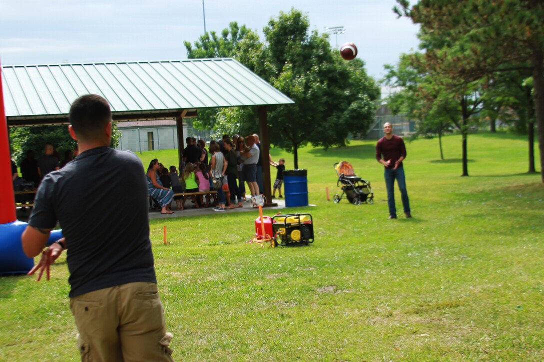 U.S. Marine Corps Sgt. Benjamin J. Annarino, left, a canvasing recruiter with Recruiting Sub-Station Richmond and a native Livonia, Michigan, throws a football to U.S. Marine Corps Staff Sgt. Samir S. Awadallah, a native of Berlin Center, Ohio and recruiter with RSS Ann Arbor, during Recruiting Station Detroit’s annual family day at Memorial Park in Royal Oak, Michigan, Aug. 8, 2015. Each one of RS Detroit’s 11 Recruiting Sub-Stations attended this event with the families.  (U.S. Marine Corps photo by Sgt. Joshua Heins/Released)