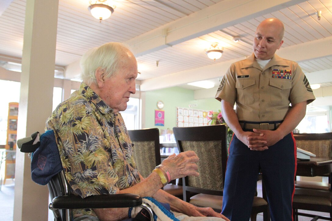 SACRAMENTO – A 100-year-old Marine, Michael Kolesar, meets Gunnery Sgt. Gerardo Ortiz, recruiting staff noncommissioned officer in charge, Marine Recruiting Station Sacramento, at the Eskaton Care Center in Greenhaven, Aug. 21. Marines met with Michael to take photos as part of the care center’s efforts to recognize centenarians. Michael fought during the famous battle of Guadalcanal. He later played professional baseball for the Browns and served as a deputy sheriff. (U.S. Marine Corps photo by Staff Sgt. Jacob Harrer / released)