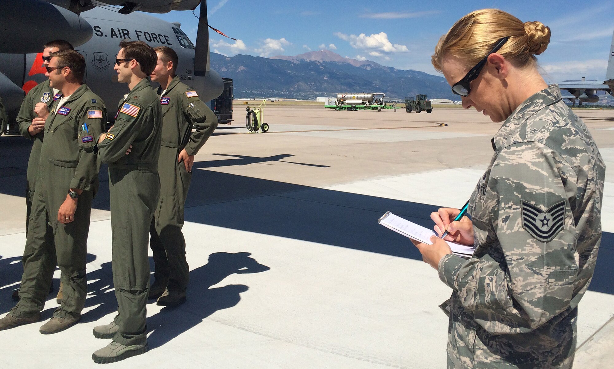 Tech Sgt. Denise Flory, 302nd Airlift Wing historian documents the Modular Airborne Fire Fighting System deployment preparations Aug., 1, 2015 at Peterson Air Force Base, Colo. Flory's special study, "Wildfire Winds: The 302nd Airlift Wing's Aerial Firefight Mission in the Colorado Springs Wildland Urban Interface, 2012-2013," received recognition as the Air Force History and Museums Program 2015 Robert F. Futrell Award for excellence in historical publications. According to the Air Force Reserve Command Historian's office, Flory is the first traditional reservist to have a special paper receive this award. (U.S. Air Force photo/Ann Skarban) 