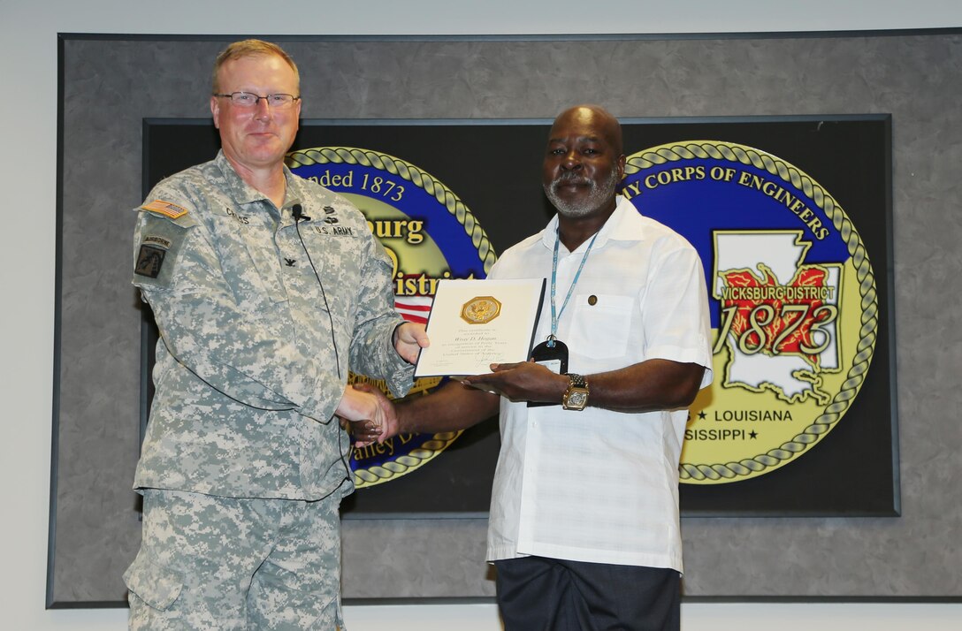 Wray Hogan received a certificate and pin for his 40 years of service in the Government of the United States of America. Hogan, also a Vietnam Era veteran, is a budget technician at the Louisiana Field Office.