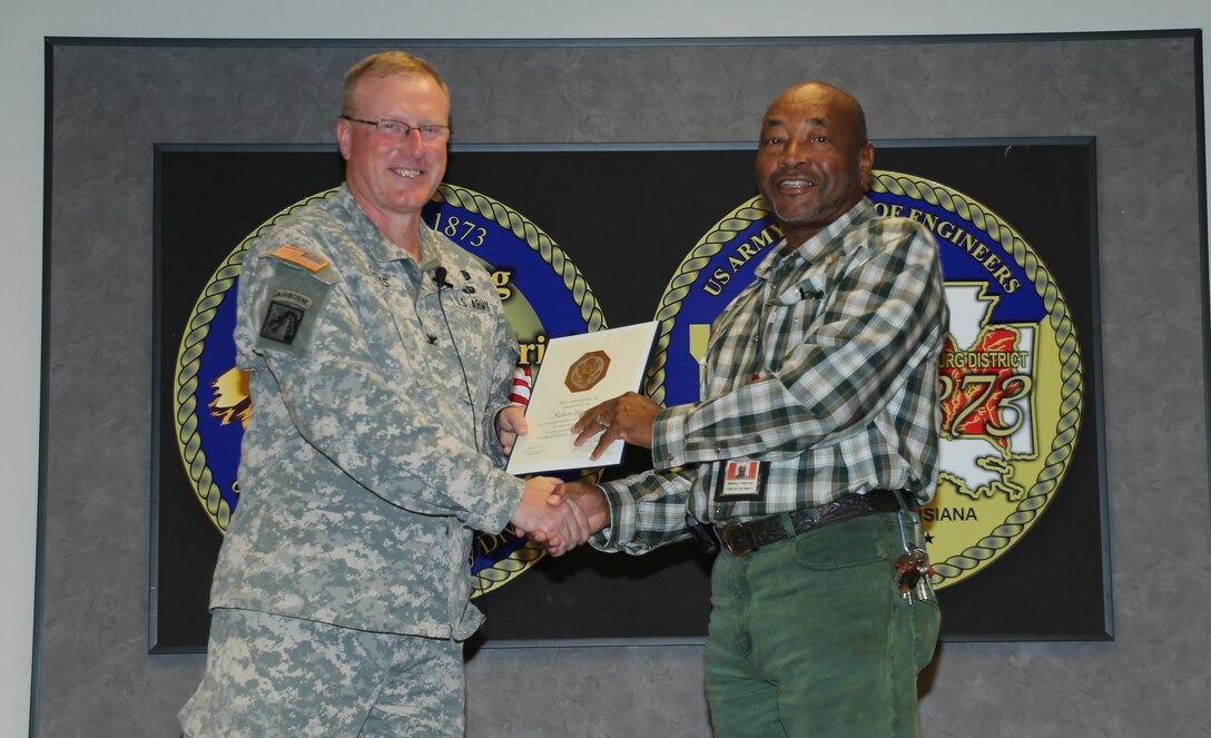 Nelson Harvey received a certificate and pin for his 40 years of service in the Government of the United States of America. Harvey is an equipment operator at the Grenada Lake Field Office.