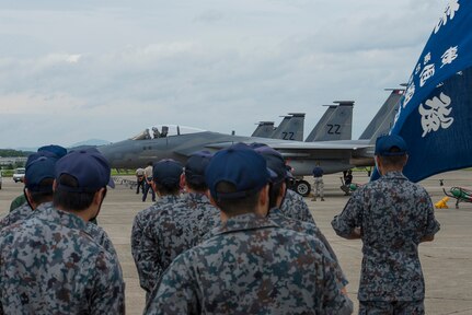 In this photo, F-15 Eagles from the 44th Fighter Squadron park in front of Japanese Air Self-Defense Force members at Tsuiki Air Base, Japan, Aug. 21, 2015. The 44th came to Tsuiki to participate in a two week long Aviation Training Relocation with Japanese Air Self-Defense Force. 