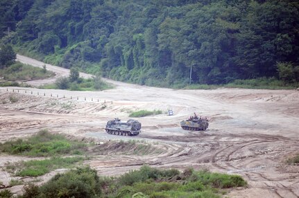 CAMP CASEY, South Korea (Aug. 20, 2015) - Soldiers, from 2nd Platoon, 1st Company, 123rd Mechanized Infantry Battalion, 73rd Regiment, 26th Infantry Division, Republic of Korea army, and Multiple Launch Rocket System crew members, from Battery B, 1st Battalion, 38th Field Artillery Regiment, 210th Field Artillery Brigade, 2nd Infantry Division/ROK-U.S. Combined Division engage a target during a combined live-fire exercise at Chipori Range, near Cheorwon. 