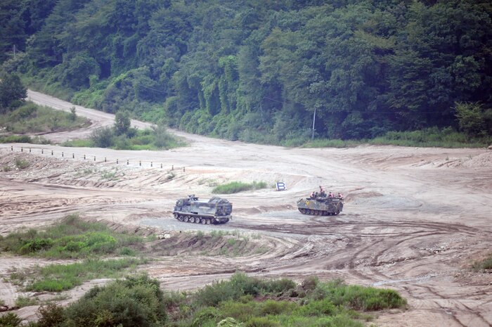 CAMP CASEY, South Korea (Aug. 20, 2015) - Soldiers, from 2nd Platoon, 1st Company, 123rd Mechanized Infantry Battalion, 73rd Regiment, 26th Infantry Division, Republic of Korea army, and Multiple Launch Rocket System crew members, from Battery B, 1st Battalion, 38th Field Artillery Regiment, 210th Field Artillery Brigade, 2nd Infantry Division/ROK-U.S. Combined Division engage a target during a combined live-fire exercise at Chipori Range, near Cheorwon. 