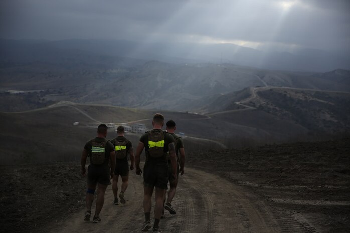 Marines assigned to Company K, 3rd Battalion, 5th Marine Regiment, 1st Marine Division, run along hills during the Dark Horse Ajax Challenge aboard Marine Corps Base Camp Pendleton, Calif., Aug. 20, 2015. The eight-mile course tested the Marines’ and Sailors’ endurance and leadership skills with trials spread across the San Mateo area. (U.S. Marine Corps photo by Cpl. Will Perkins)