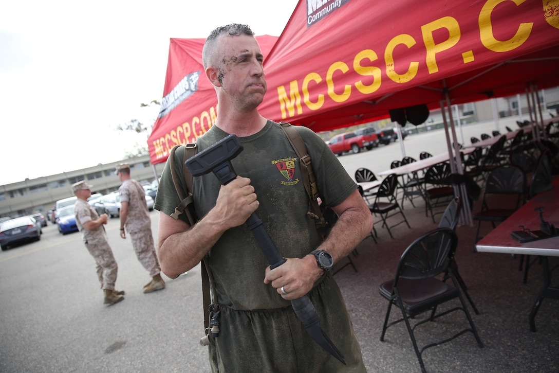 Lieutenant Colonel Hunter Rawlings, battalion commander, 3rd Battalion, 5th Marine Regiment, 1st Marine Division, prepares to present the first place prize for completion of the Dark Horse Ajax Challenge aboard Marine Corps Base Camp Pendleton, Calif., Aug. 20, 2015. The eight-mile course tested the Marines’ endurance and leadership skills with trials spread across the San Mateo area. (U.S. Marine Corps photo by Cpl. Will Perkins)