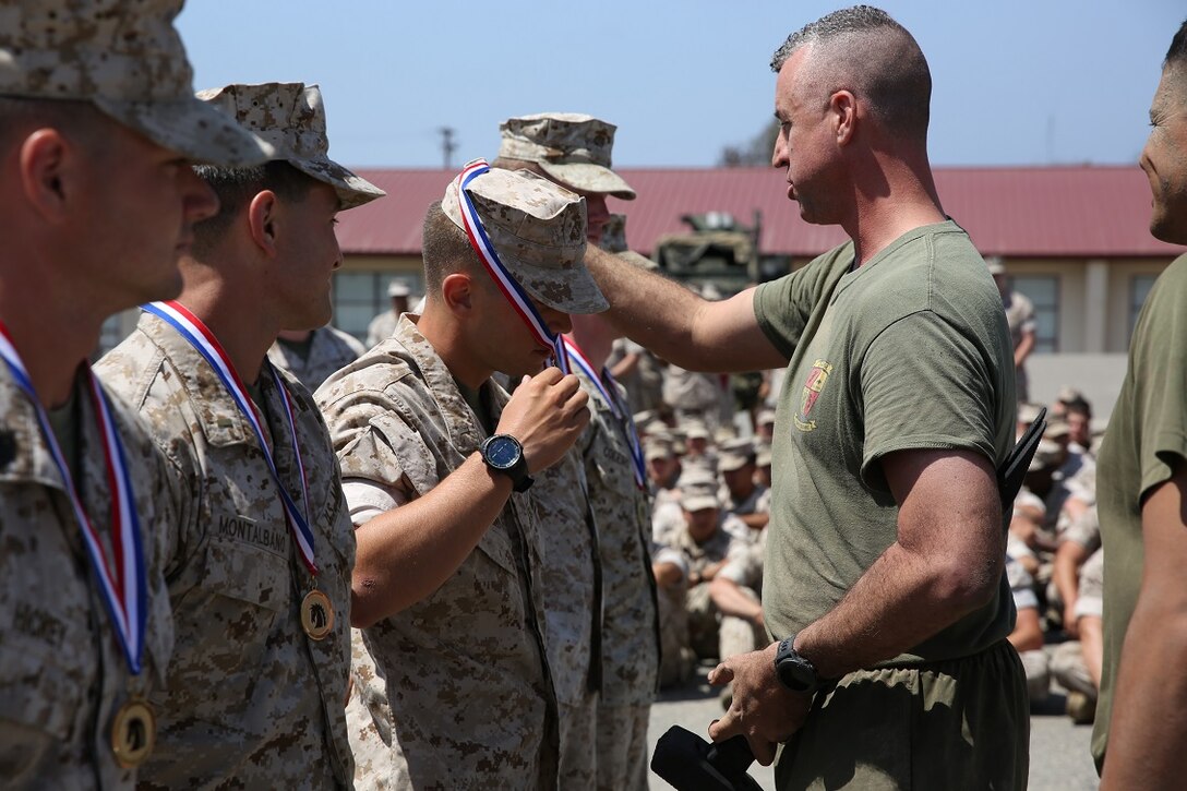 Lieutenant Colonel Hunter Rawlings, battalion commander, 3rd Battalion, 5th Marine Regiment, 1st Marine Division, presents the first place medals to the Marines with Company L, 3/5, 1st Mar. Div., after completing the Dark Horse Ajax Challenge aboard Marine Corps Base Camp Pendleton, Calif., Aug. 20, 2015. The eight-mile course tested the Marines’ and Sailors’ endurance and leadership skills with trials spread across the San Mateo area. (U.S. Marine Corps photo by Cpl. Will Perkins)