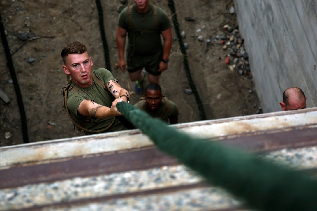 A Marine assigned to Company K, 3rd Battalion, 5th Marine Regiment, 1st Marine Division, climbs a rope as part of the Dark Horse Ajax Challenge aboard Marine Corps Base Camp Pendleton, Calif., Aug. 20, 2015. The eight-mile course tested the Marines’ and Sailors’ endurance and leadership skills with trials spread across the San Mateo area. (U.S. Marine Corps photo by Cpl. Will Perkins)