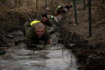 Marines assigned to Company K, 3rd Battalion, 5th Marine Regiment, 1st Marine Division, low-crawl through a trench during the Dark Horse Ajax Challenge aboard Marine Corps Base Camp Pendleton, Calif., Aug. 20, 2015. The eight-mile course tested the Marines’ and Sailors’ endurance and leadership skills with trials spread across the San Mateo area. (U.S. Marine Corps photo by Cpl. Will Perkins)