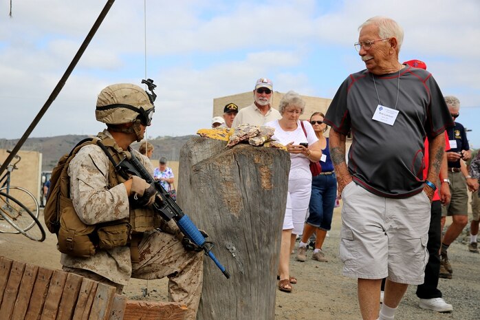 Vietnam veterans a part of the 1st Marine Division Association observe Marines with 2nd Battalion, 1st Marine Regiment, 1st Mar. Div., as they train in a simulated combat environment during the 68th annual 1st Mar. Div. Association reunion, aboard Marine Corps base Camp Pendleton, Calif., Aug. 20, 2015. During the reunion, veterans visited their old stomping grounds and reminisced about their days serving in the division, while also observing the capabilities of today’s Marines. (U.S. Marine Corps photo by Cpl. Demetrius Morgan/RELEASED)