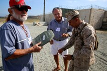 Corporal Jesus Mier, a light armored vehicle crewman with Company C, 1st Light Armored Reconnaissance Battalion, 1st Marine Division, talks with a Vietnam veteran that is a member of the 1st Mar. Div. Association during the 68th annual reunion, aboard Marine Corps base Camp Pendleton, Calif., Aug. 20, 2015. During the reunion, veterans visited their old stomping grounds and reminisced about their days serving in the division, while also observing the capabilities of today’s Marines. (U.S. Marine Corps photo by Cpl. Demetrius Morgan/RELEASED)