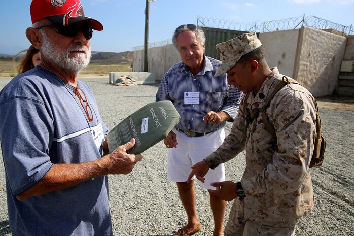 Corporal Jesus Mier, a light armored vehicle crewman with Company C, 1st Light Armored Reconnaissance Battalion, 1st Marine Division, talks with a Vietnam veteran that is a member of the 1st Mar. Div. Association during the 68th annual reunion, aboard Marine Corps base Camp Pendleton, Calif., Aug. 20, 2015. During the reunion, veterans visited their old stomping grounds and reminisced about their days serving in the division, while also observing the capabilities of today’s Marines. (U.S. Marine Corps photo by Cpl. Demetrius Morgan/RELEASED)