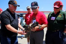 Vietnam veterans a part of the 1st Marine Division Association observe an M32 Multi-shot Grenade Launcher during the 68th annual 1st Mar. Div. Association reunion, aboard Marine Corps base Camp Pendleton, Calif., Aug. 20, 2015. During the reunion, veterans visited their old stomping grounds and reminisced about their days serving in the division, while also observing the capabilities of today’s Marines. (U.S. Marine Corps photo by Cpl. Demetrius Morgan/RELEASED)