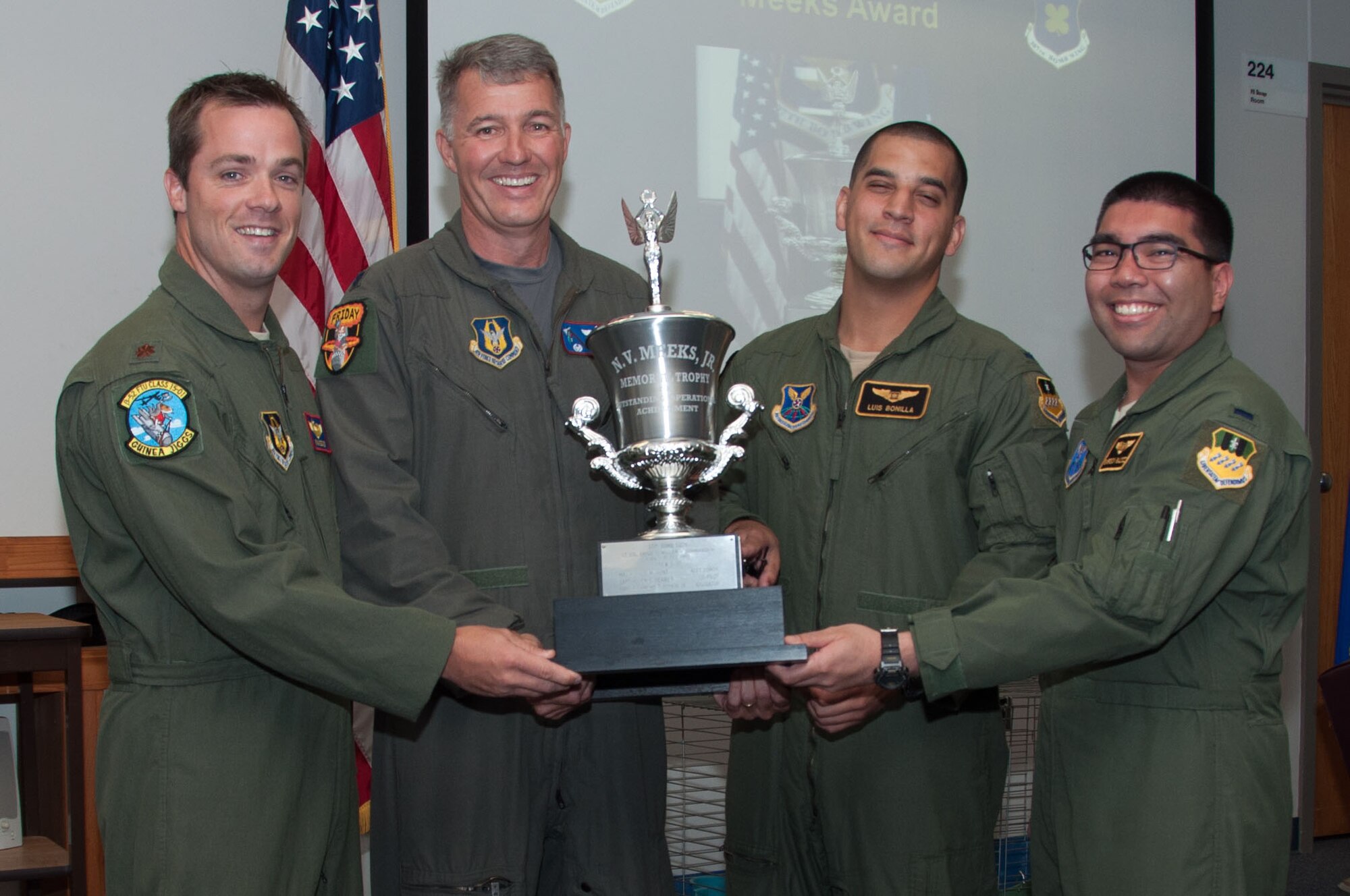 U.S. Air Force Lt. Col. Robert Van Hoy, 93rd Bomb Squadron commander, presents the Meeks Outstanding Crew Award to crew TUFF 22 during a Formal Training Unit graduation ceremony, Aug. 19, 2015, Barksdale Air Force Base, La. The award is presented to the student aircrew that performs the best throughout the flight line phase of training, and the crew members are Pilot –Major Ryan Decker , Weapon Systems Officer–1st  Lt. Luis Bonilla, Electronic Warfare Officer – 1st Lt. Emerson Baldoz, (U.S. Air Force photo by Master Sgt. Laura Siebert /Released)