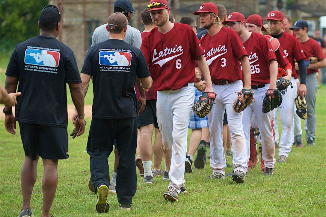 U.S. soldiers shake hands with members of the Latvian National Team after a baseball game in Riga, Latvia, Aug. 8, 2015. The esprit de corps developed during the game increased  camaraderie among Latvian and U.S. soldiers deployed to the region for Operation Atlantic Resolve