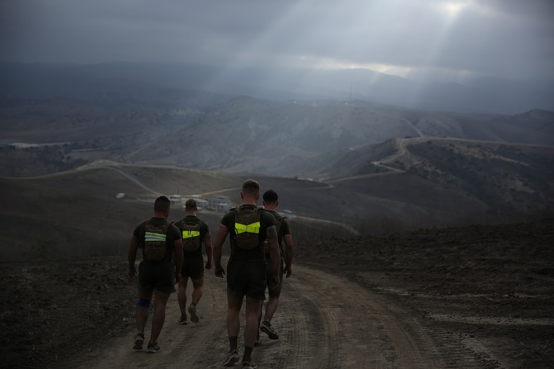 Marines assigned to Company K, 3rd Battalion, 5th Marine Regiment, 1st Marine Division, run along hills during the Dark Horse Ajax Challenge aboard Marine Corps Base Camp Pendleton, Calif., Aug. 20, 2015. The eight-mile course tested the Marines’ and Sailors’ endurance and leadership skills with trials spread across the San Mateo area.