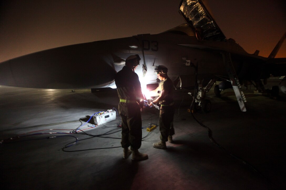 U.S. Marines with Marine Fighter Attack Squadron 232, Special Purpose Marine Air-Ground Task Force—Crisis Response—Central Command, perform maintenance on an F/A-18 Hornet in Southwest Asia June 9, 2015. Pilots of VMFA-232 support Combined Joint Task Force – Operation Inherent Resolve with a combination of surveillance flights and kinetic strike missions, enabling Iraqi Security Forces in their fight against the Islamic State of Iraq and the Levant. 