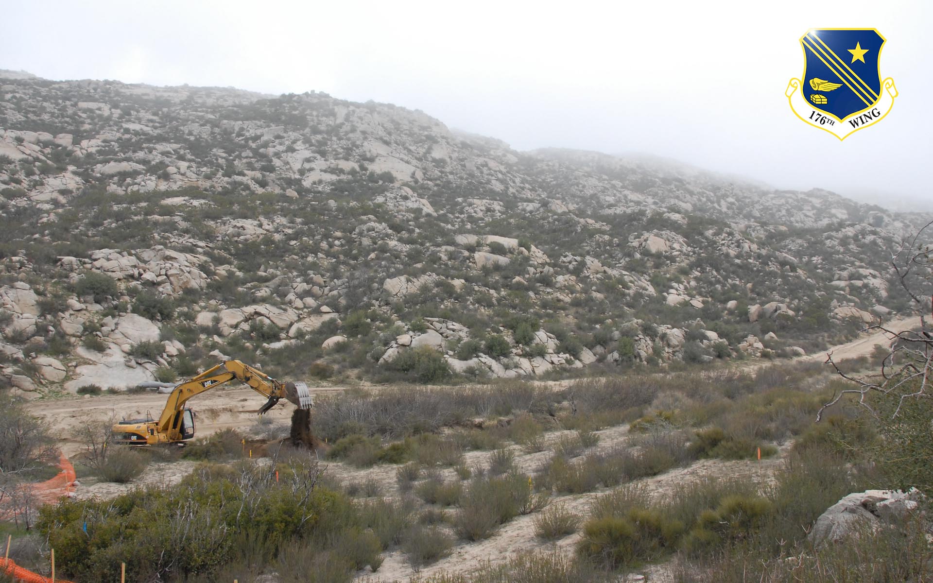 An excavator belonging to the Alaska National Guard's 176th Civil Engineer Squadron repairs a roadway along the California-Mexico border as part of Operation Jump Start on Feb. 19, 2008.