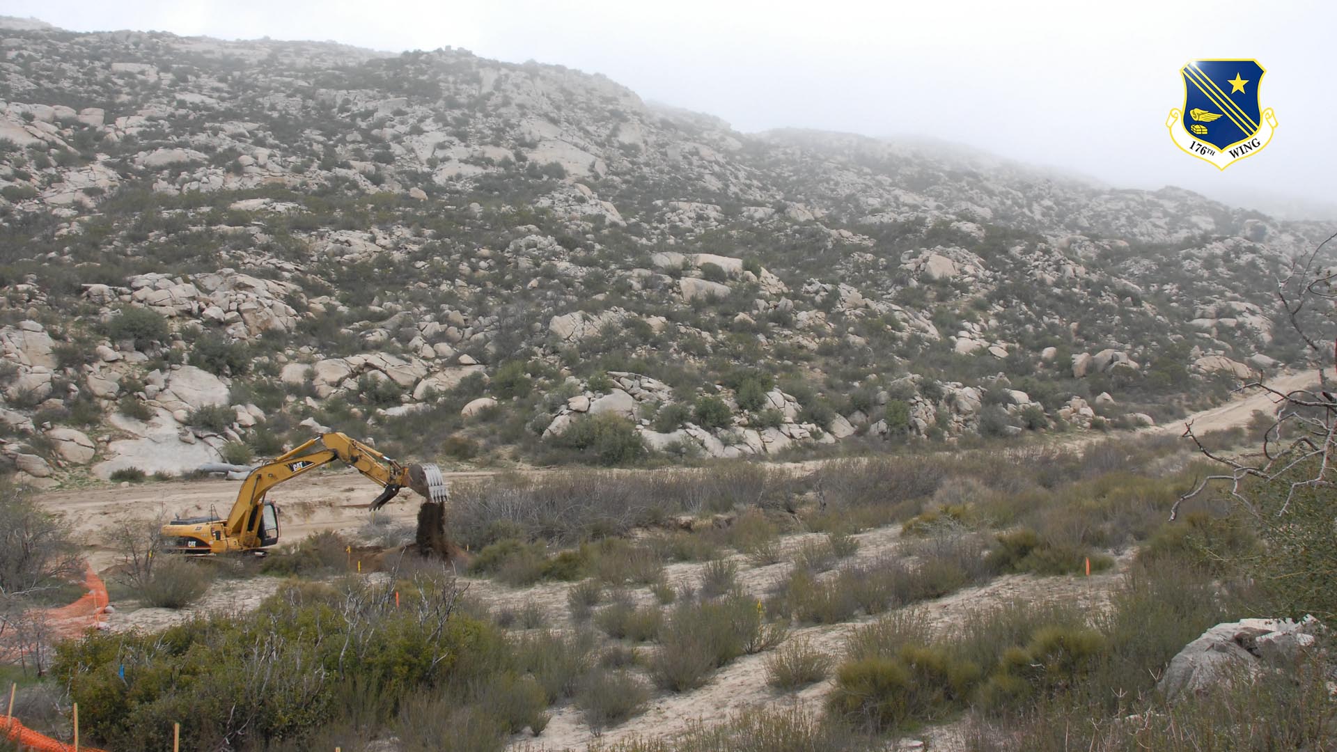 An excavator belonging to the Alaska National Guard's 176th Civil Engineer Squadron repairs a roadway along the California-Mexico border as part of Operation Jump Start on Feb. 19, 2008.