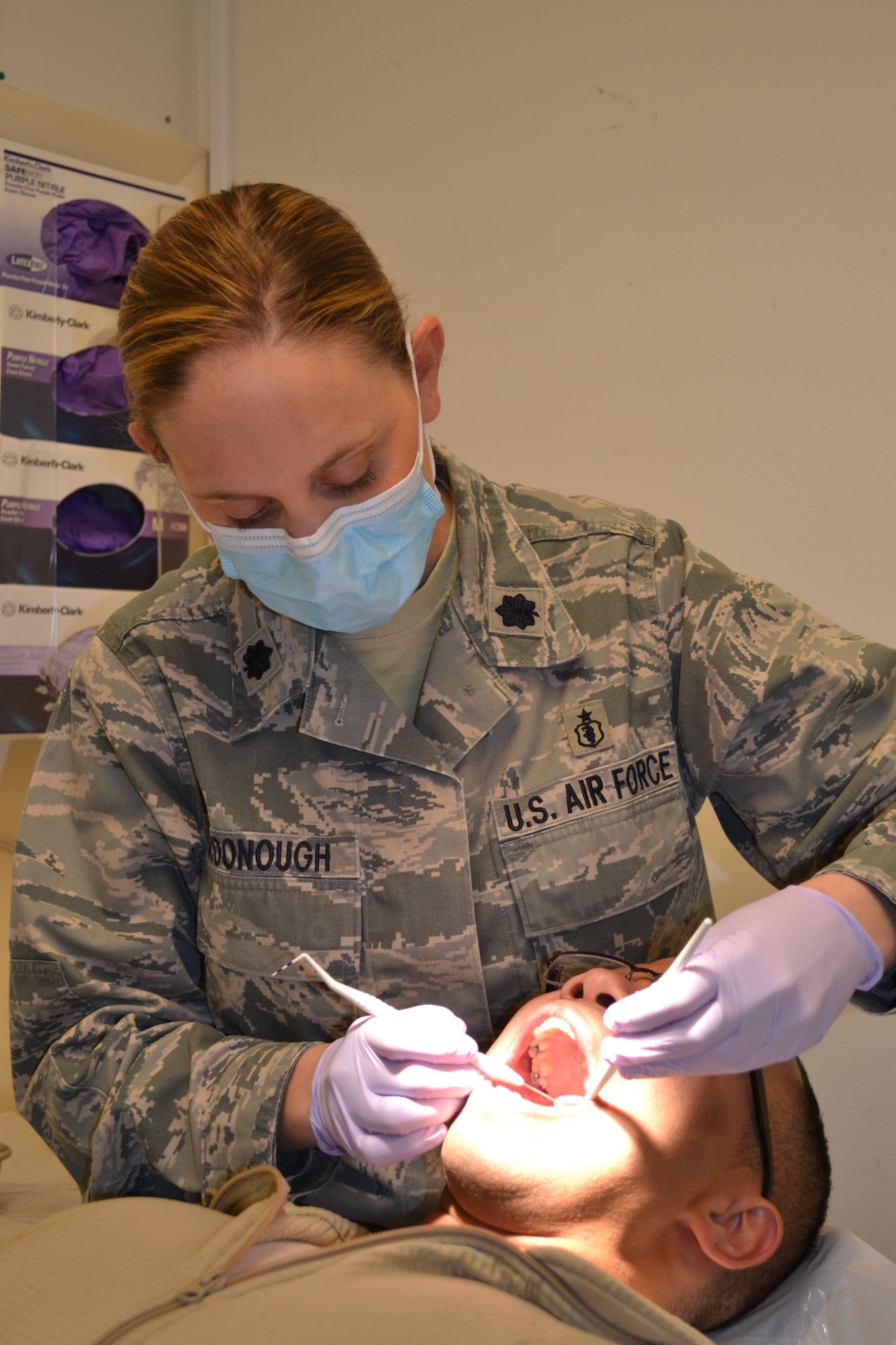 Lt. Col. Angela McDonough, 111th Attack Wing dental clinic officer-in-charge, provides a dental exam in the medical facility April 24, 2015, at Horsham Air Guard Station, Pennsylvania. The dental staff now has walk-in hours available during the week for in-status Guardsmen. (U.S. Air National Guard photo by Tech. Sgt. Andria Allmond/Released)
