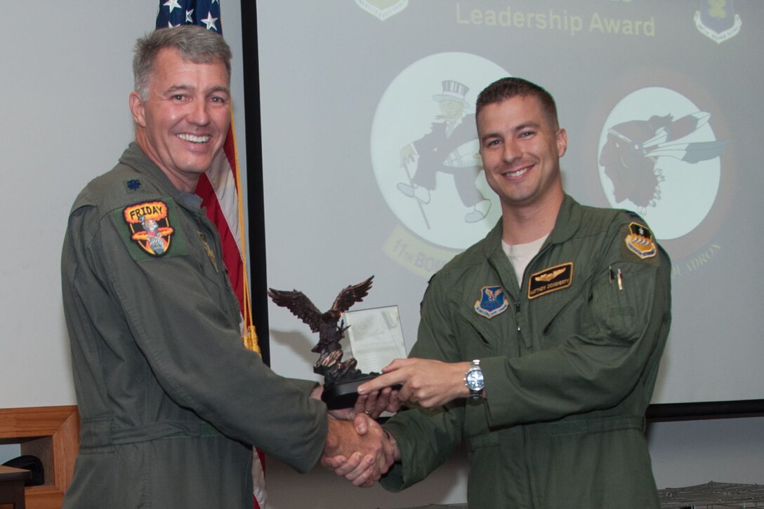 U.S. Air Force Lt. Col. Robert Van Hoy, 93rd Bomb Squadron commander, presents the Lindell Mabus Leadership Award to Capt. Matthew Doughtery during a Formal Training Unit graduation ceremony, Aug. 19, 2015 Barksdale Air Force Base, La. Doughtery was selected by his fellow class members for his exceptional leadership, which was critical to the class's graduation. (U.S. Air Force photo by Master Sgt. Laura Siebert /Released)