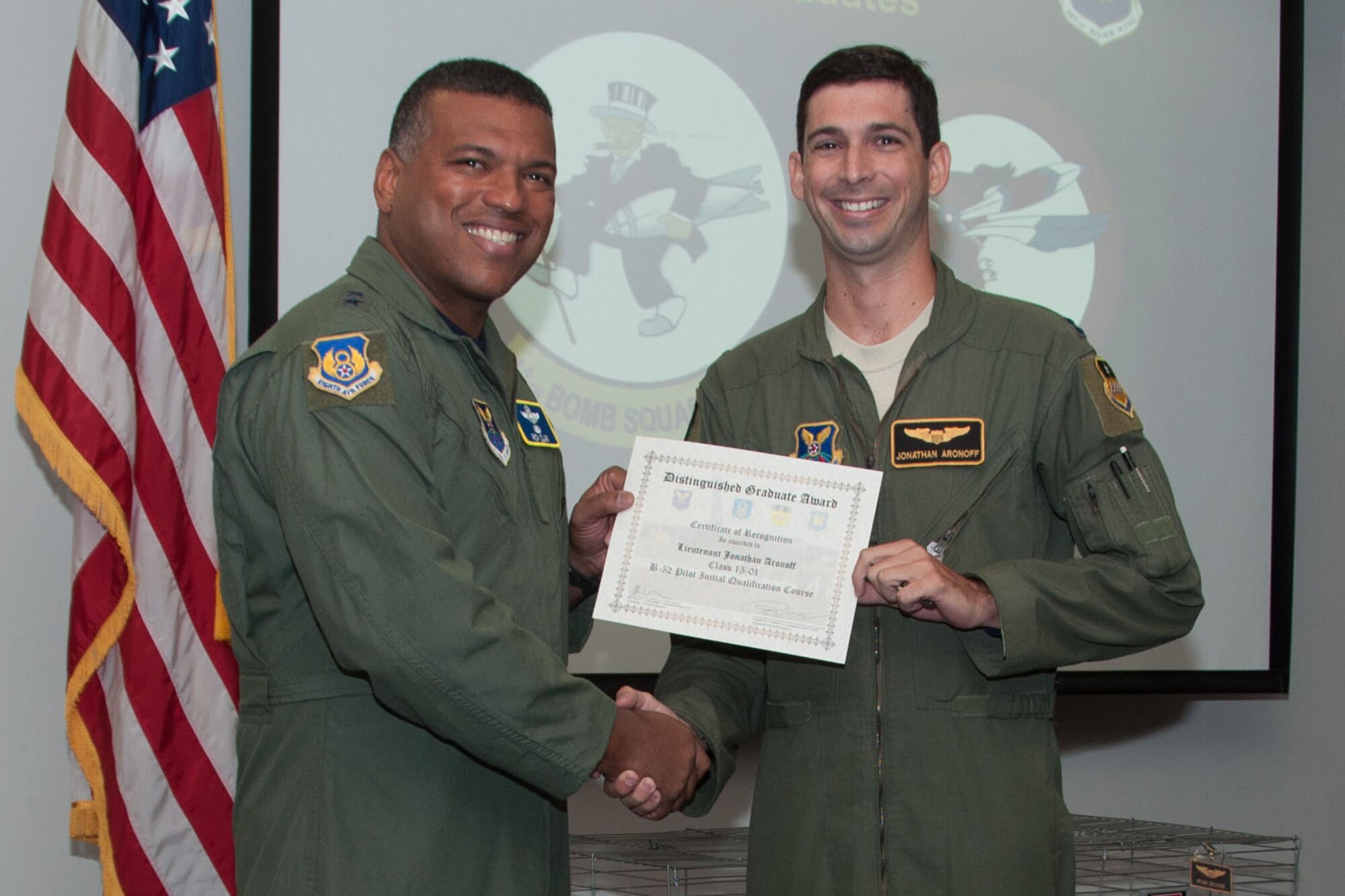 U.S. Air Force, Major General Richard Clark, commander of 8th Air Force, presents the Pilot Distinguished Graduate Award to Capt. Jonathan Aronoff during a Formal Training Unit (FTU) graduation ceremony, Aug. 19, 2015, Barksdale Air Force Base, La. Aronoff graduated from the FTU as a pilot on the B-52H Stratofortress. (U.S. Air Force photo by Master Sgt. Laura Siebert /Released)