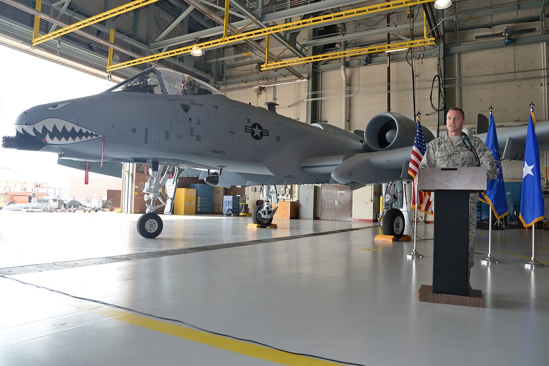 Brig. Gen. Carl Buhler, Ogden Air Logistics Complex commander speaks at a ceremony marking the 100th A-10 completed in the Enhanced Wing Assembly Program by the 571st Aircraft Maintenance Squadron at Hill Air Force Base. (Air Force photo by Alex R. Lloyd)
