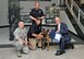Arnold Police K-9 officer Bo, a Belgian Malinois, is presented with a certificate of appreciation from Manchester Police Department (MPD) Chief of Police Mark Yother (far right) on June 10 at AEDC for bomb threat assistance at two Manchester schools. Bo’s handler and Arnold Police Officer Aaron Cheney (second from left, kneeling) and Arnold Police Officer Jason Layne (not pictured) also received certificates of appreciation. AEDC Commander Col. Raymond Toth (kneeling) and MPD Maj. Bill Sipe are also pictured. (Photo by Jacqueline Cowan)