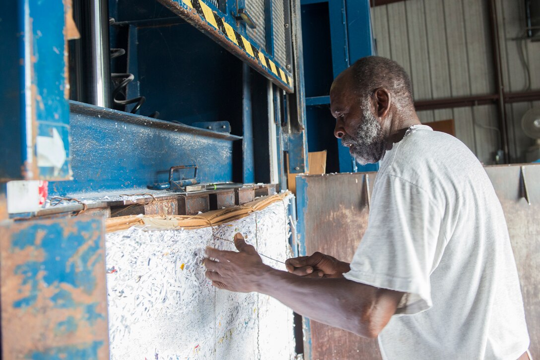 James Clemons, recycling center operator, uses a baler to compact paper at the recycling center Aug. 20, 2015, at Moody Air Force Base, Ga. The recycling center uses balers to compact all paper and then ship off the bundles when they reach 40,000 pounds. Moody’s recycling center recycles a variety of items to include: paper, aluminum, plastic, scrap metal and wood. (U.S. Air Force photo by Airman 1st Class Ceaira Tinsley/Released)