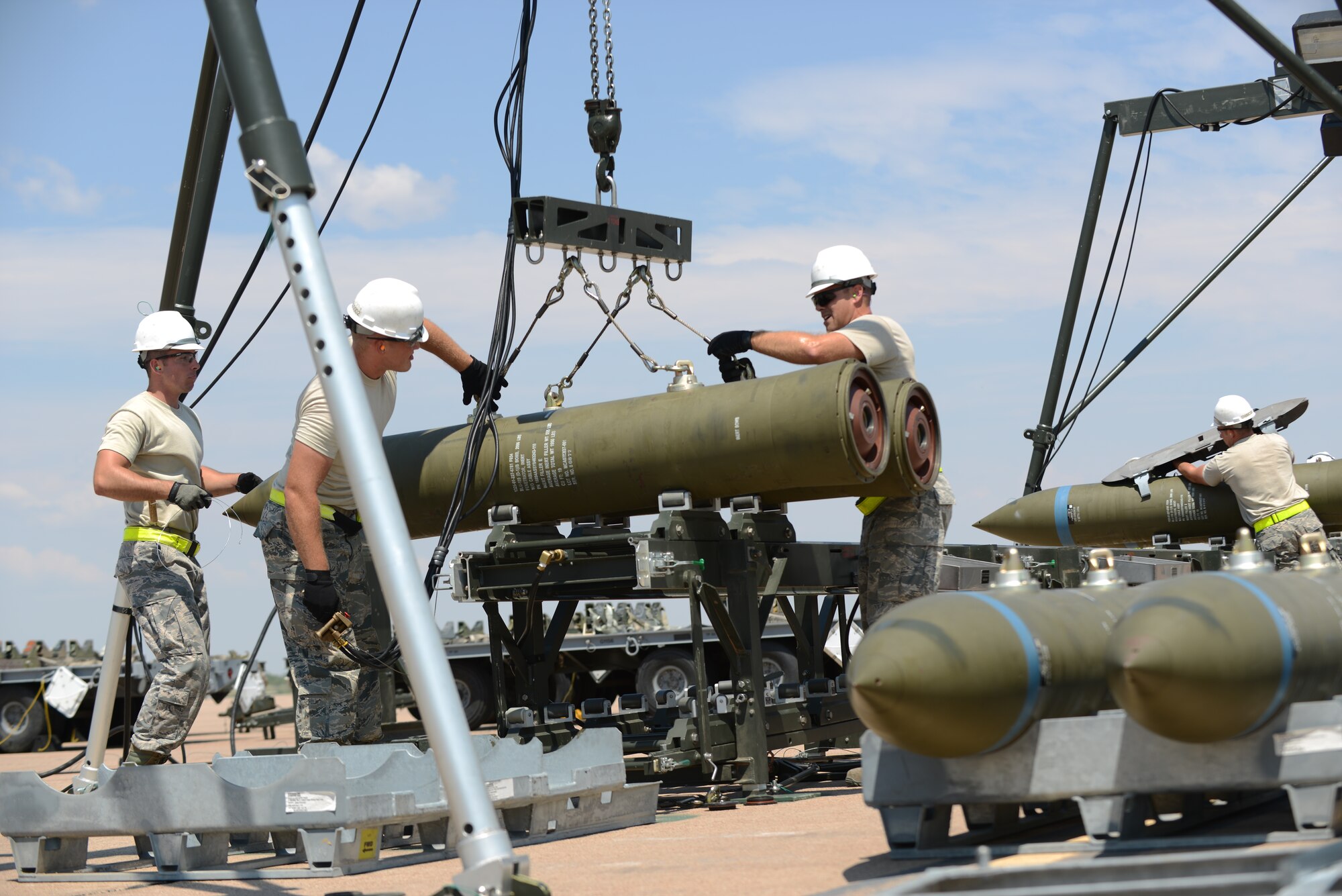 U.S. Air Force Airmen, assigned to the 7th Munitions Squadron, begin building an inert-guided bomb unit during the 2015 Global Strike Challenge Aug. 17, 2015, at Dyess Air Force Base, Texas. The competition recognizes the “best of the best” in the world’s premier bomber force, maintenance and security forces units and also reflects normal operations when deployed to a forward operating location. (U.S. Air Force photo by Senior Airman Kedesha Pennant/Released)