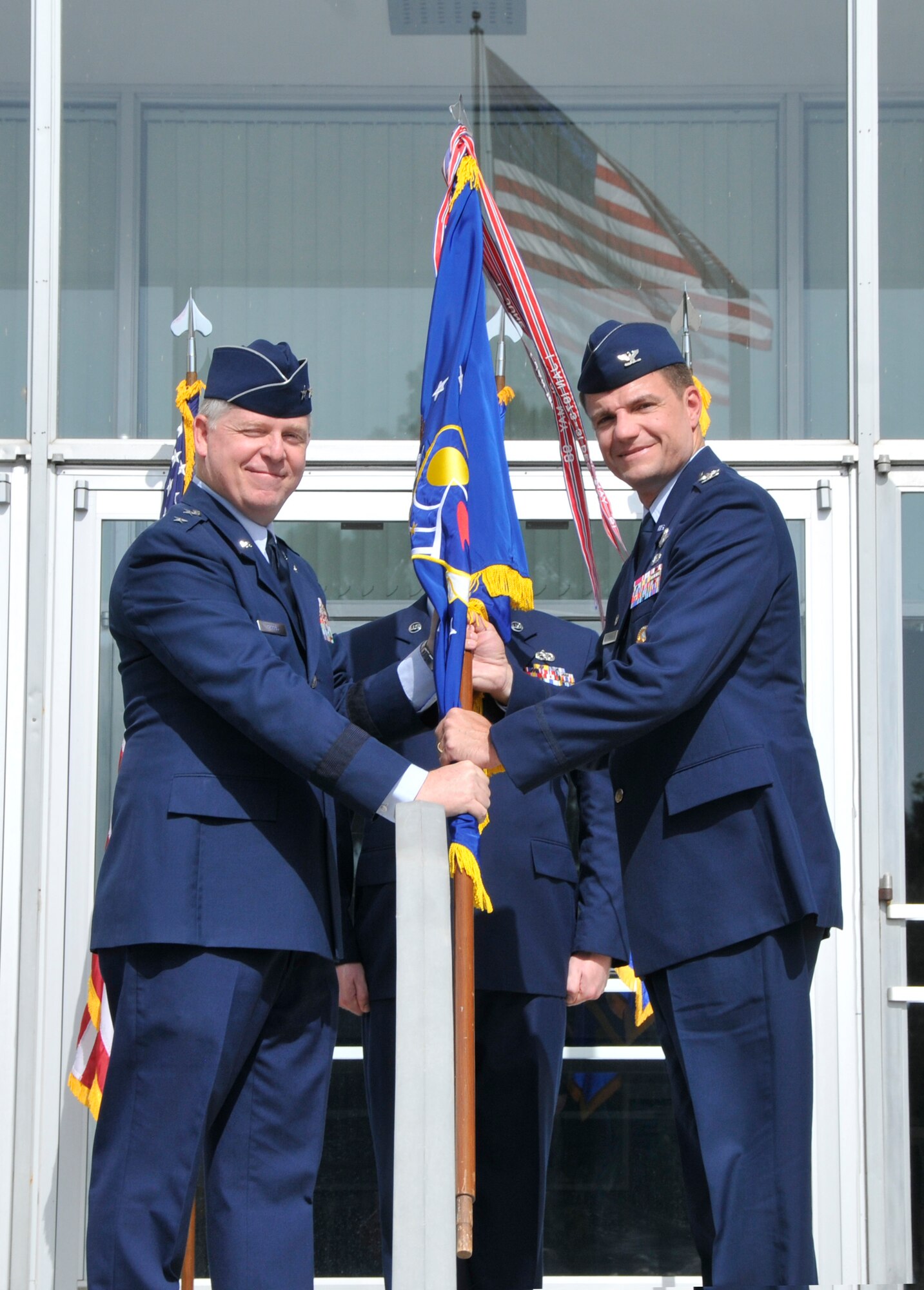 Air Force Test Center Commander Maj. Gen. David A. Harris, left, presents the Arnold Engineering Development Complex flag to the newly-designated Complex Commander Col. Rodney F. Todaro during an assumption of command ceremony Jul. 8 at the Administration and Engineering building. (Photo by Jacqueline Cowan)