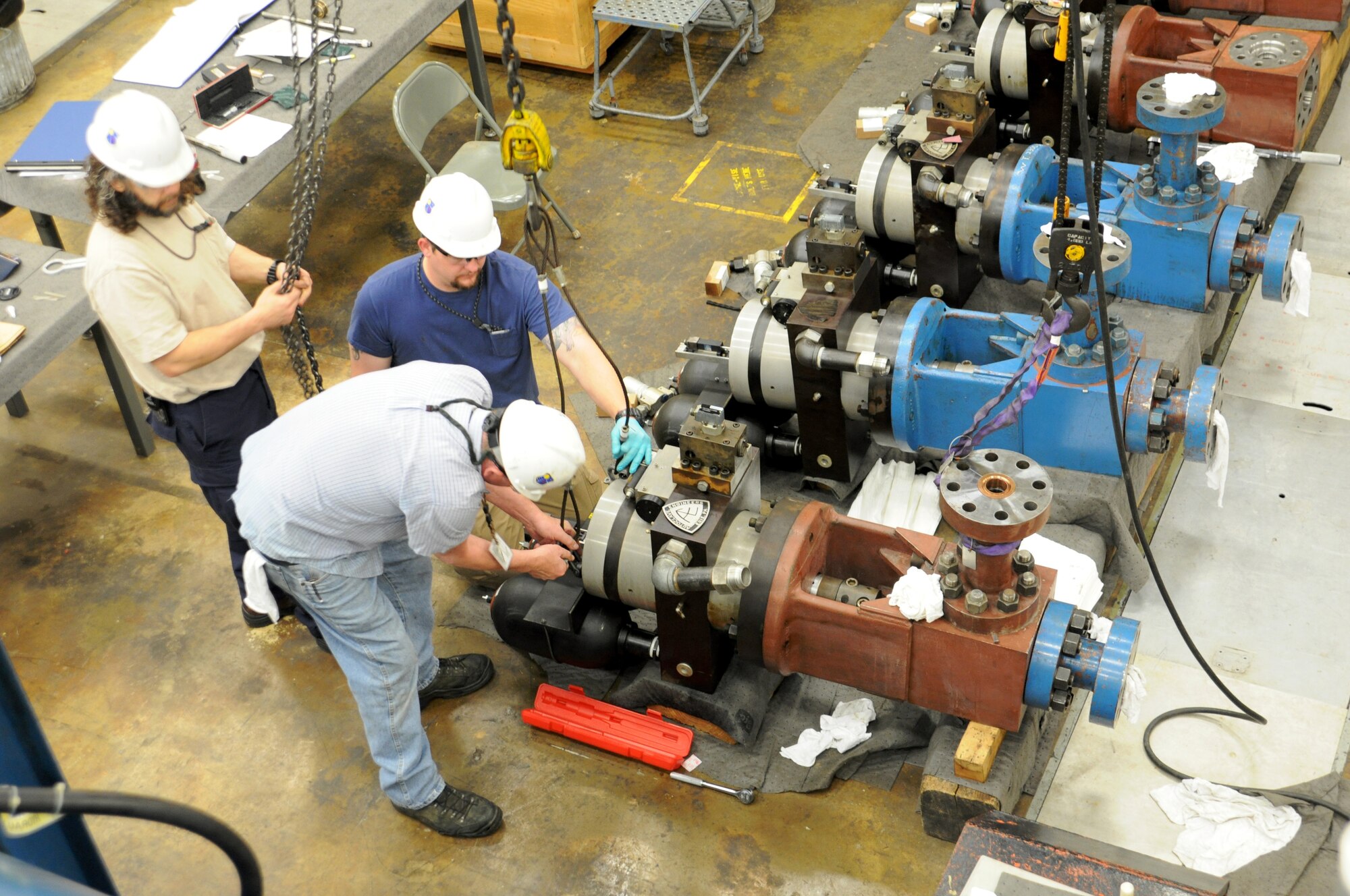 An extensive outage for maintenance occurs at Hypervelocity Wind Tunnel 9 once every five to ten years. After a complete tear down and refurbishment, the facility’s operation and maintenance staff rig one of nine high-pressure control valves in order to lift it into place. These valves are uniquely designed to handle the volumetric flow rates of the wind tunnel.  (Photo by AJ Spicer)