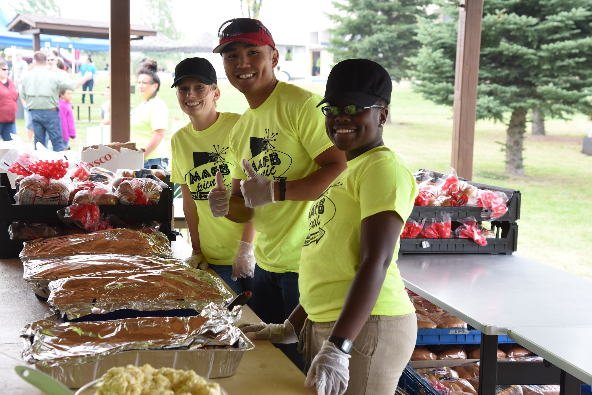 Team Malmstrom members prepare to serve food during a base picnic at Sun Plaza Park at Malmstrom Air Force Base Aug 21.  Volunteers helped serve lunch to Airmen, civilians, retirees and family members at the annual event. (U.S. Air Force Photo/Airman 1st Class Collin Schmidt) 