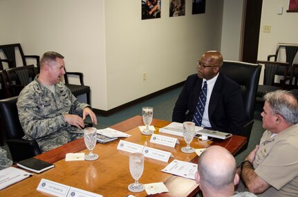(Middle) Kevin Walker, Defense Business Board member, receives a brief from Joint Base Charleston leadership, August 20, 2015 at JB Charleston – Air Base, S.C. The Defense Business Board provides the Secretary and Deputy Secretary of Defense, as well as other senior leaders, trusted independent and objective advice reflecting a private sector perspective on proven and effective best business practices for potential application to the Department. (U.S. Air Force photo/Staff Sgt. AJ Hyatt)