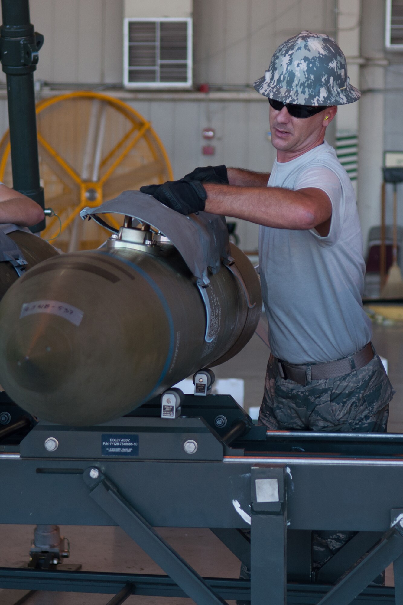 U.S. Air Force Staff Sgt. Eric Taylor, a Munitions System Craftsman, begins assembly on a BLU-109 bomb body as part of the Global Strike Challenge Competition on Barksdale Air Force Base, La. on Aug. 14, 2015. The team from the Munitions Flight of the 307th Maintenance Squadron is competing against other units in Air Force Global Strike Command for the honor of winning the Ellis Giant Sword Trophy. (U.S. Air Force photo by Master Sgt. Dachelle Melville/Released)