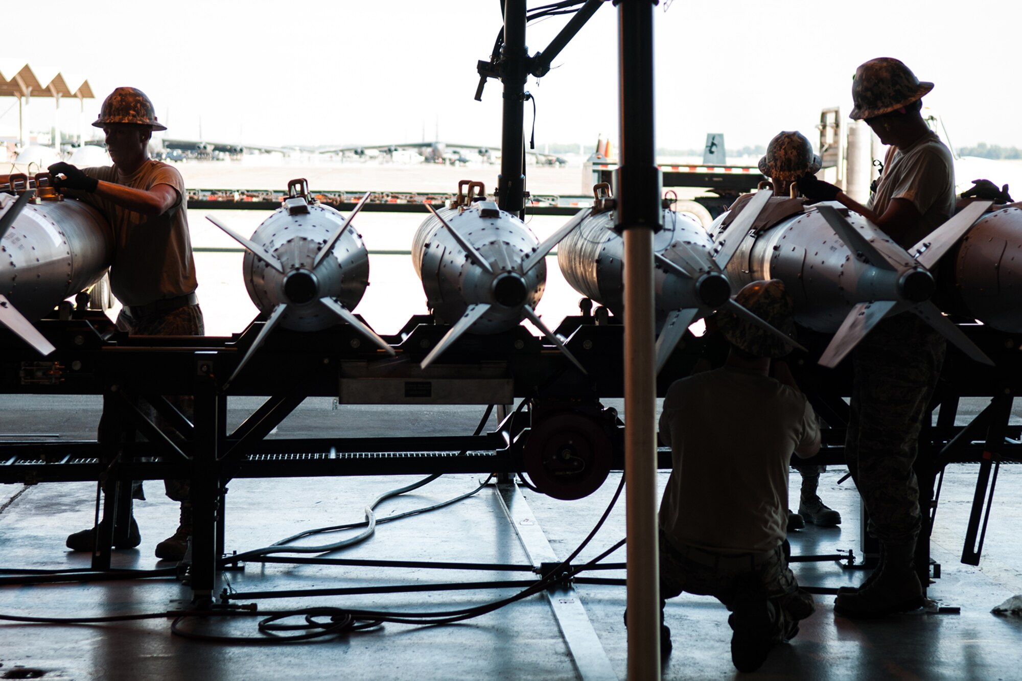 U.S. Air Force Airmen of the 307th Maintenance Squadron’s Munitions Flight build inert bombs as part of the Global Strike Challenge on Aug. 14, 2015 on Barksdale Air Force Base, La. The competition for the munitions flight consists of assembly of the Munitions Assembly Conveyor, a conventional bomb build and vehicle operating challenges. (U.S. Air Force photo by Master Sgt. Dachelle Melville/Released)