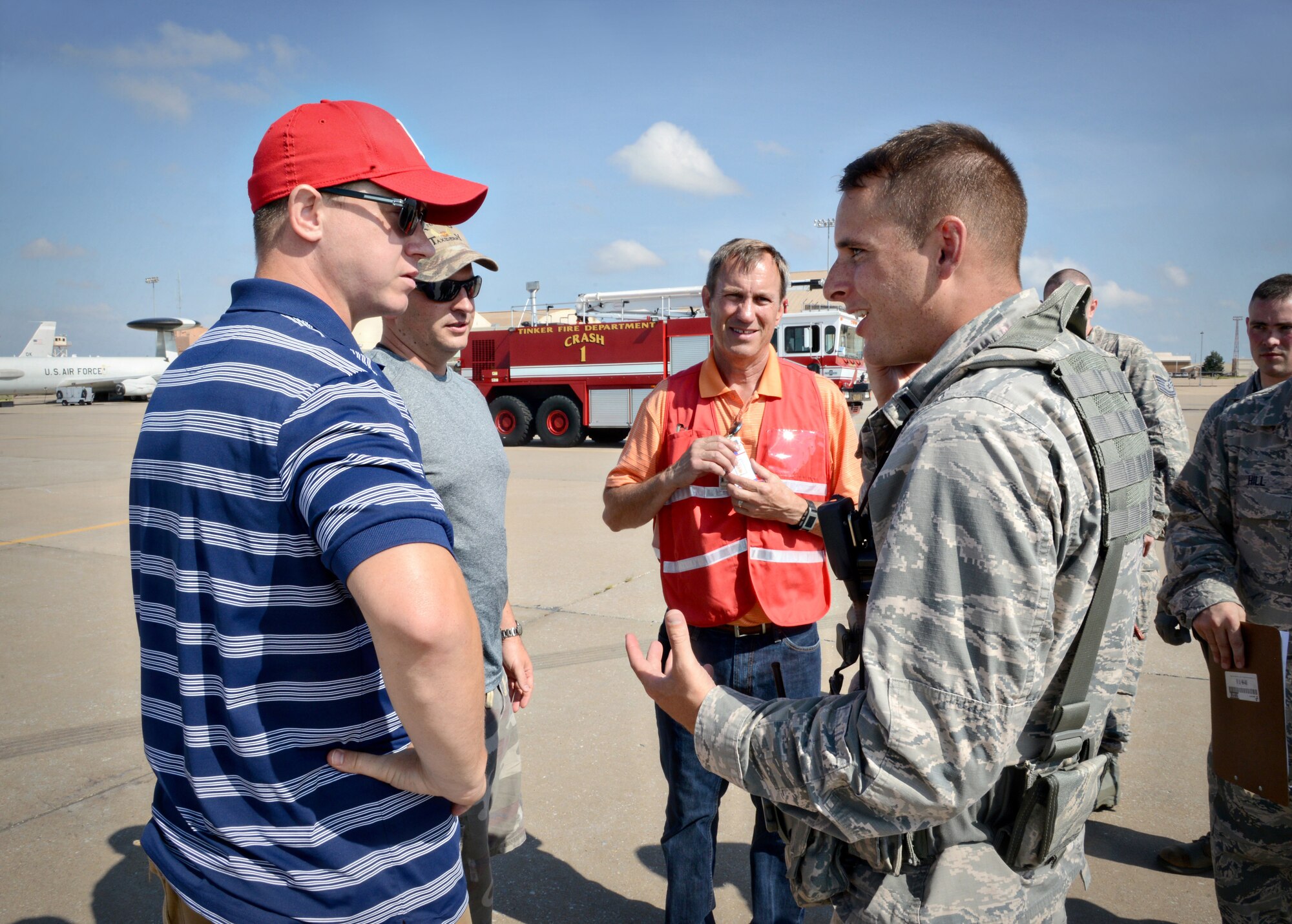 From left, Tech. Sgt. David Mercer, with the 552nd Air Control Wing’s Safety Office; Maj. Ryan Eads, with the 552nd ACW’s Inspector General’s office; and Paul Logan, with the 72nd Air Base Wing Inspector General’s office, talk to 72nd Security Forces Squadron’s 1st Lt. Justin Clouser about the Aug. 11 exercise they all had a part in. The scenario for the exercise was an active shooter/anti-hijacking exercise that helped inspect various units on Tinker Air Force Base. The IG offices create various scenarios throughout the year to ensure first responders, medics and other essential personnel know correct protocol and procedures if a real-world event should ever occur. (Air Force photo by Kelly White/Released)

