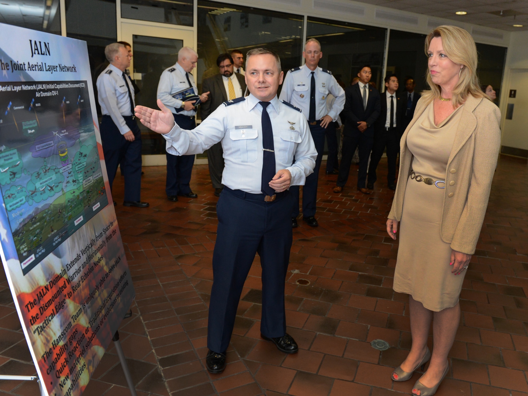 Col. Todd Krueger, Space, Aerial and Nuclear Networks Division senior materiel leader, provides an overview to Secretary of the Air Force Deborah Lee James on the Joint Aerial Layer Network during a capabilities demonstration on base Aug. 21. James is visiting Hanscom to gain more knowledge about the base’s mission and people. (U.S. Air Force photo by Jerry Saslav)