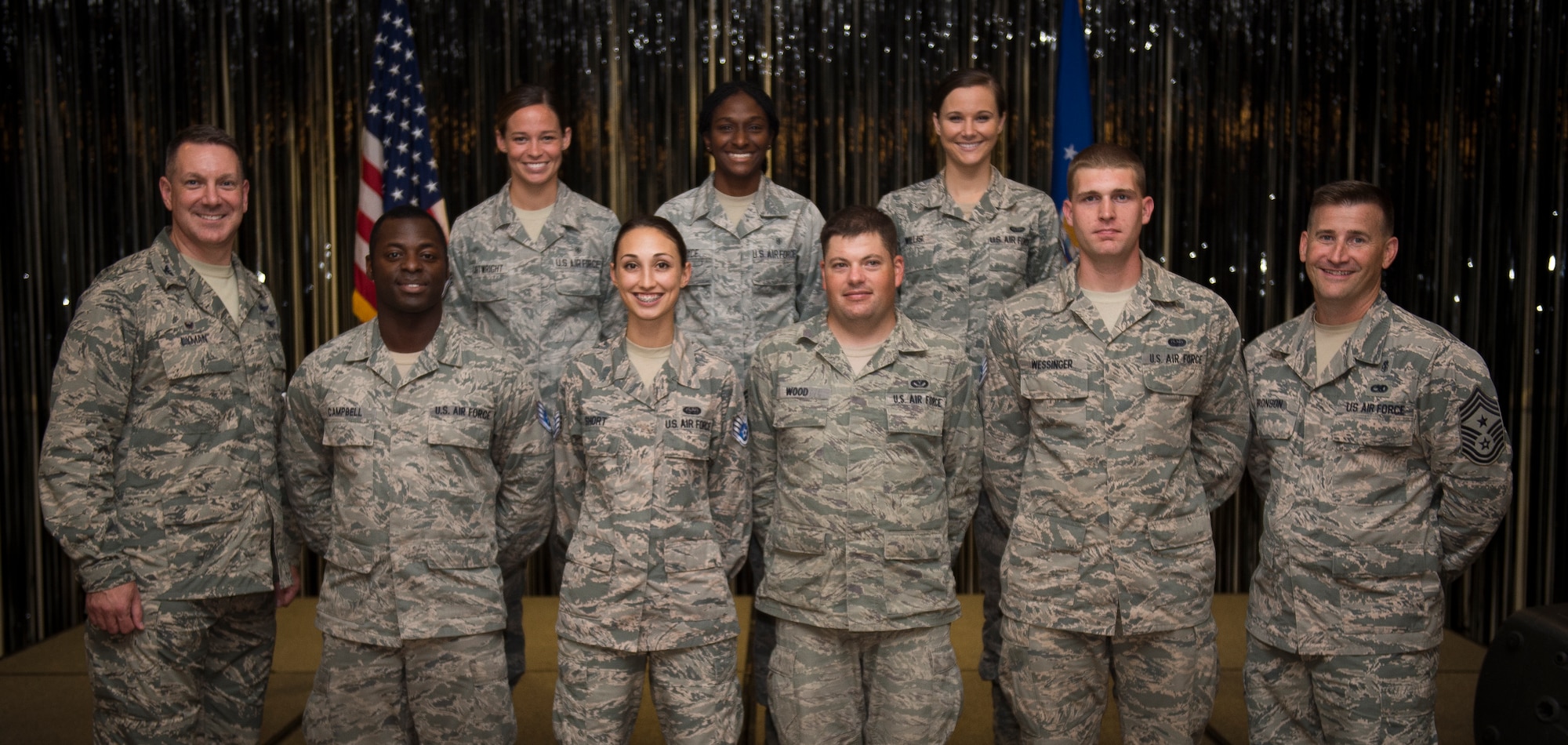 Col. Robert Lyman, Joint Base Charleston commander (left) and Chief Master Sgt. Mark Bronson, 628th Air Base Wing command chief (right), stand with Staff Sgt. selects from the 628th ABW Aug. 20, 2015, at the Charleston Club on Joint Base Charleston, S.C. The purpose of the event was to highlight the achievement, acknowledge the selectees and give them an opportunity to celebrate and socialize with other selectees, friends and family. (U.S. Air Force photo/Airman 1st Class Clayton Cupit)