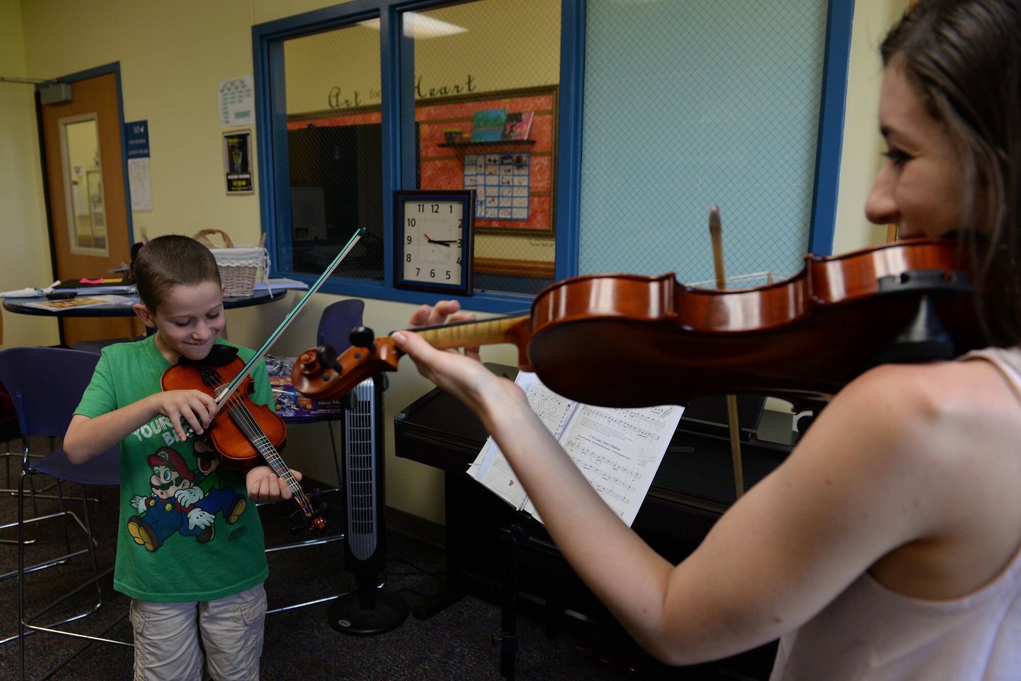Ryan Cooper, 9, plays notes during a repeating game with Katlyn Zunker, Youth Center Violin Instructor, July 30, 2015, Scott Air Force Base, Ill. The Youth Center has classes available for ballet, violin, tap dance, gymnastics and piano. Violin classes are held Monday through Friday for ages 5 and up. (U.S. Air Force photo by Airman 1st Class Erica Holbert-Siebert)