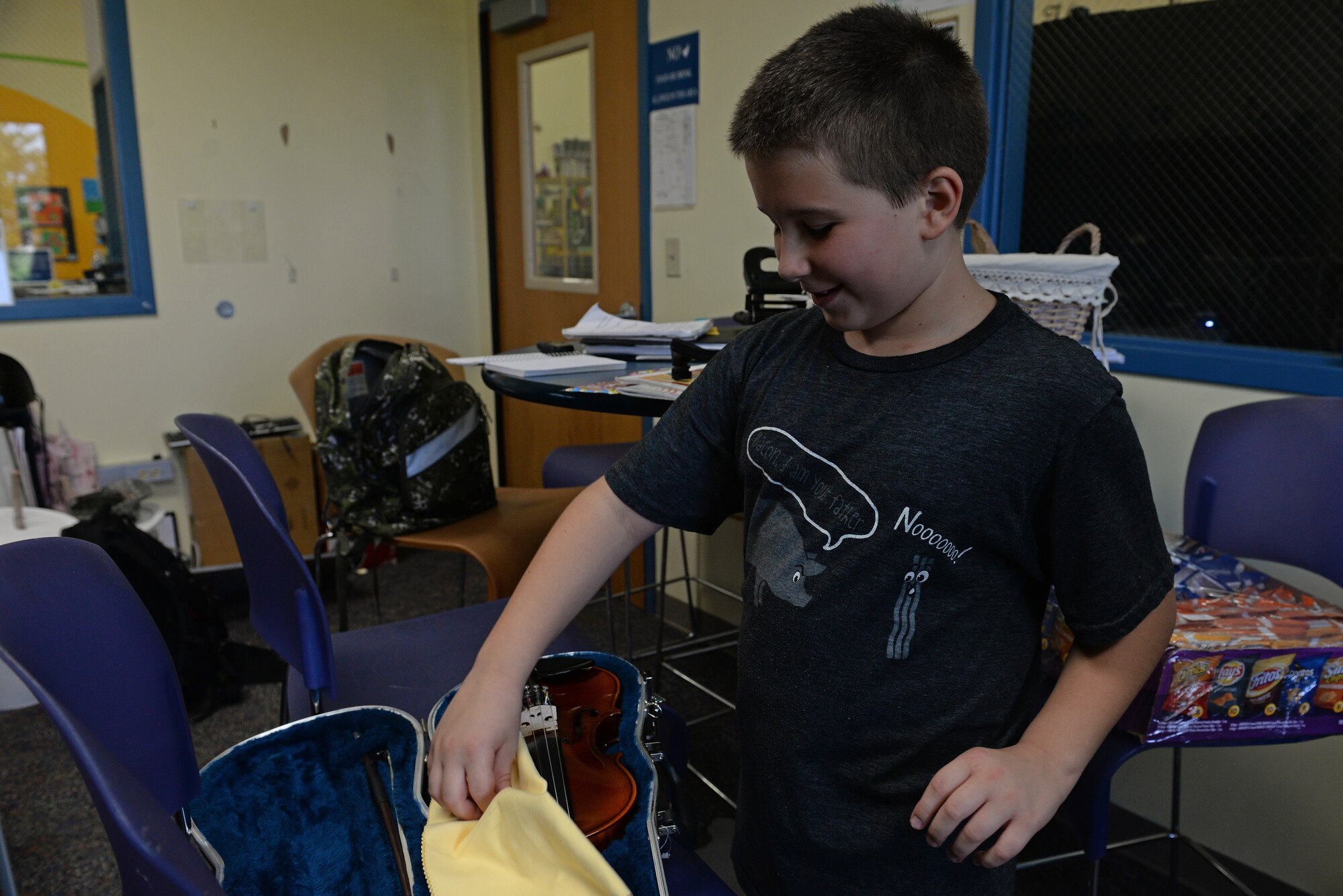 Adam Clark, 9, practices his violin during lessons with his instructor, Katlyn Zunker, July 30, 2015, Scott Air Force Base, Ill. One exercise he does is called bow exercises, that help him learn to use more of the bow and he has gotten past the point of remembering which string is which, where he had colored tape as a reminder. (U.S. Air Force photo by Airman 1st Class Erica Holbert-Siebert)