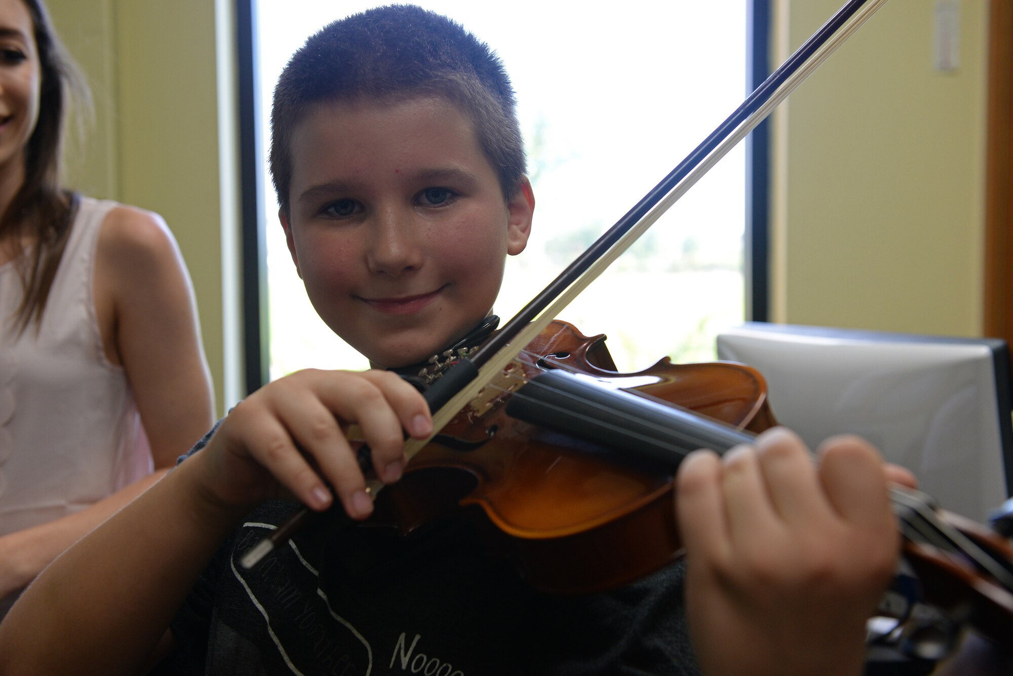 Adam Clark, 9, practices his violin during lessons with Katlyn Zunker, Youth Center Violin Instructor, July 30, 2015, Scott Air Force Base, Ill. One exercise he does is called bow exercises, that help him learn to use more of the bow and he has gotten past the point of remembering which string is which, where he had colored tape as a reminder. (U.S. Air Force photo by Airman 1st Class Erica Holbert-Siebert)