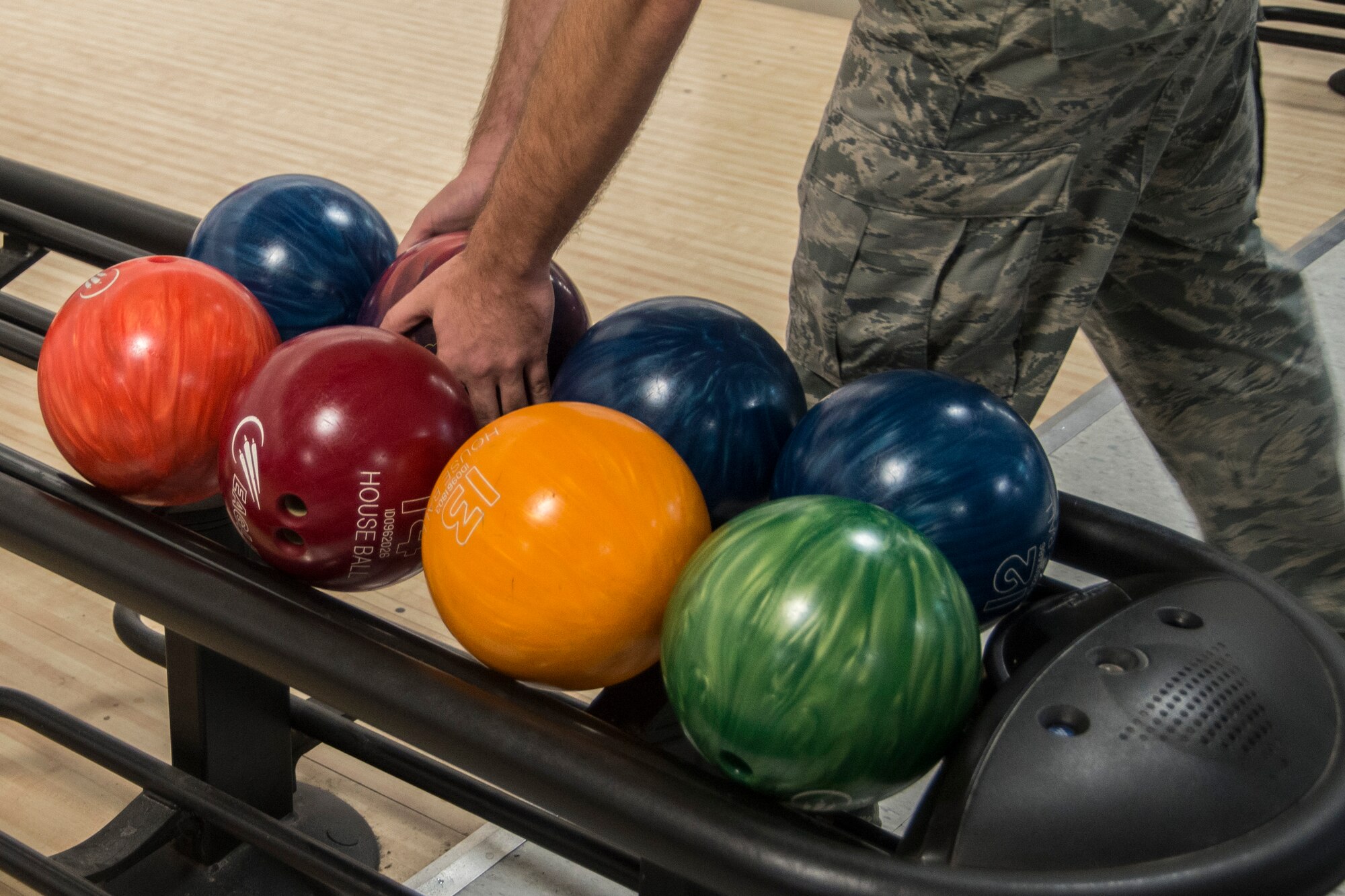 An Airman chooses a bowling ball during the Sexual Assault Prevention and Response "Back to School Bowl-a-thon" at  Stars and Strikes Bowling Center,  August 13, 2015, at Scott Air Force Base, Ill. The goal of the event was to provide important sexual assault information in a stress free environment. (U.S. Air Force photo by Airman 1st Class Melissa Estevez)