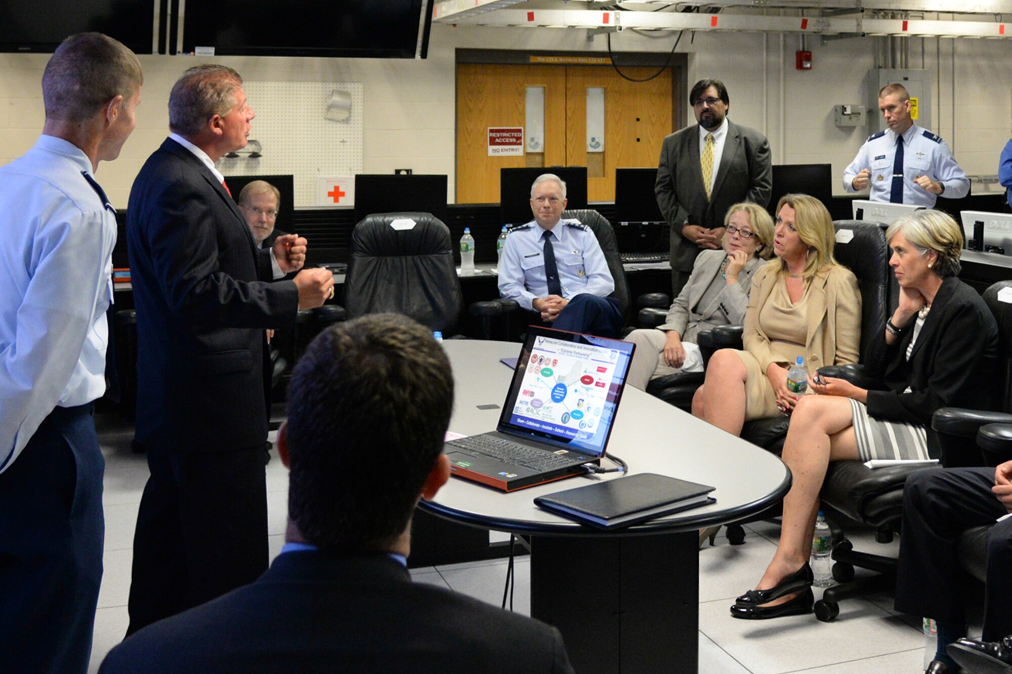 During a Hanscom Collaboration and Innovation Center capabilities demonstration, Secretary of the Air Force Deborah Lee James, center, U.S. Rep. Niki Tsongas, left, and U.S. Rep. Katherine Clark and others are briefed by Joel Rodriquez, adjunct to the chief technology officer, during a visit to the base Aug. 21. James and the members of the Mass. congressional delegation also saw program demonstrations and received briefings from each of the program executive officers and the base commander. (U.S. Air Force photo by Linda LaBonte Britt)