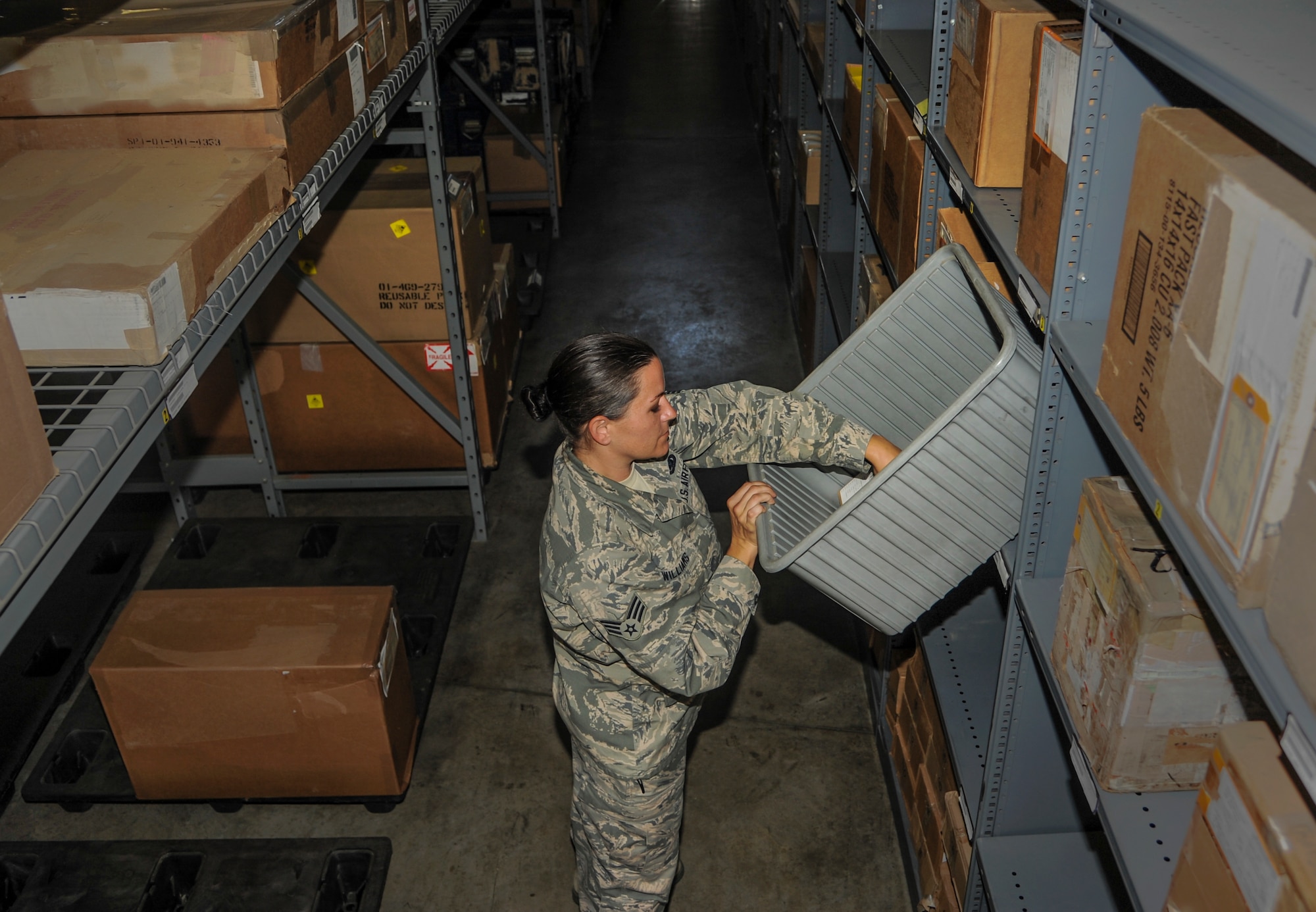 Senior Airman Jennifer Williams, a 189th Logistics Readiness Squadron individual equipment/central storage element journeyman, inspects aircraft parts stored in a supply warehouse Aug. 17, 2015, at Little Rock Air Force Base, Ark. Along with inspections, Williams coordinates with unit deployment managers to verify clothing requirements for future deployments. (U.S. Air Force photo by Senior Airman Harry Brexel)